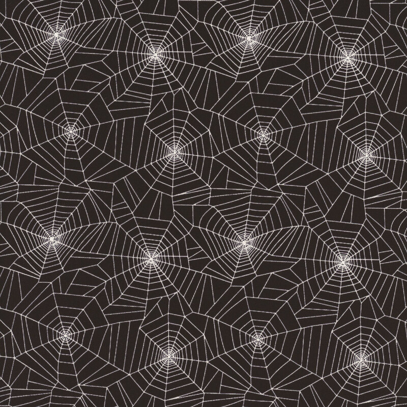 white spider webs on black fabric