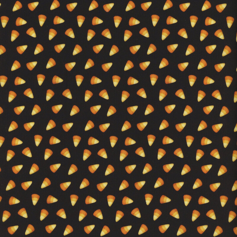 ditzy yellow, tangerine, and dark orange candy corn on a black background.