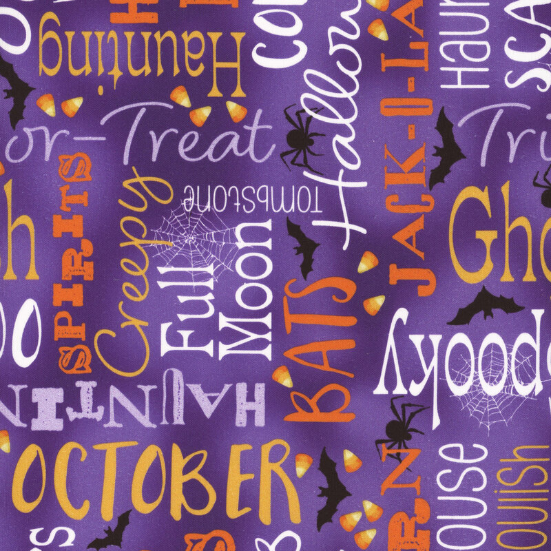 mottled purple fabric featuring Halloween-themed words, spider webs, spiders, bats, and candy corn in colors of yellow, orange, purple, and white.
