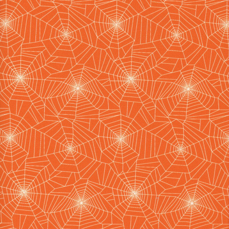 white spider webs on orange fabric