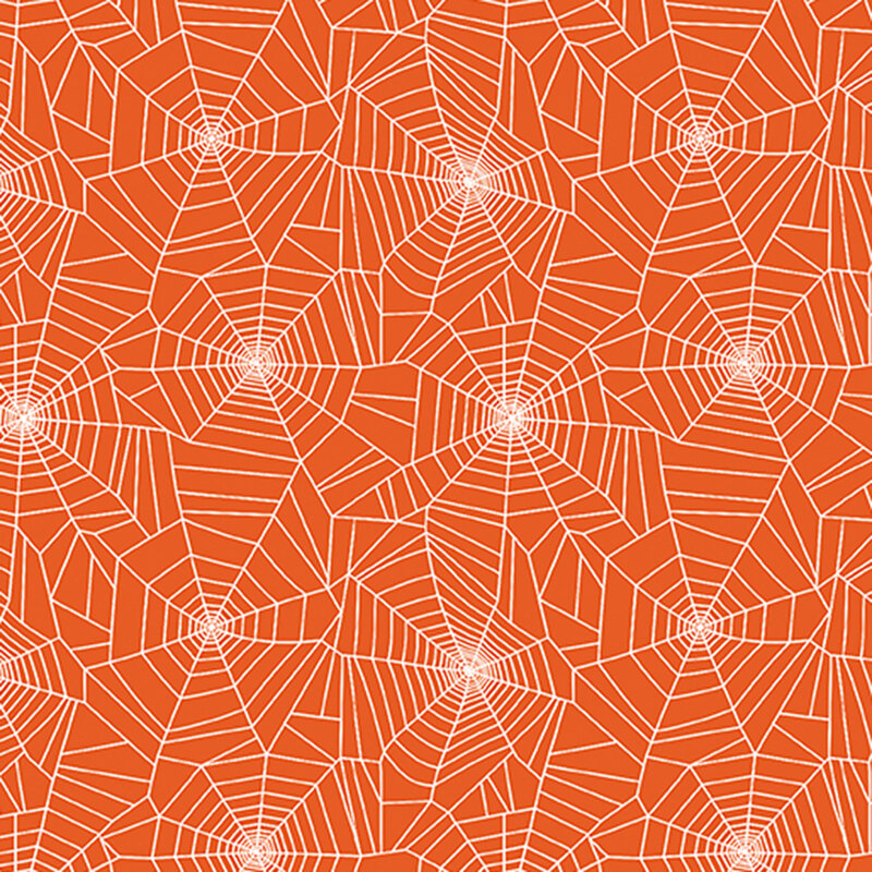 white spider webs on orange fabric