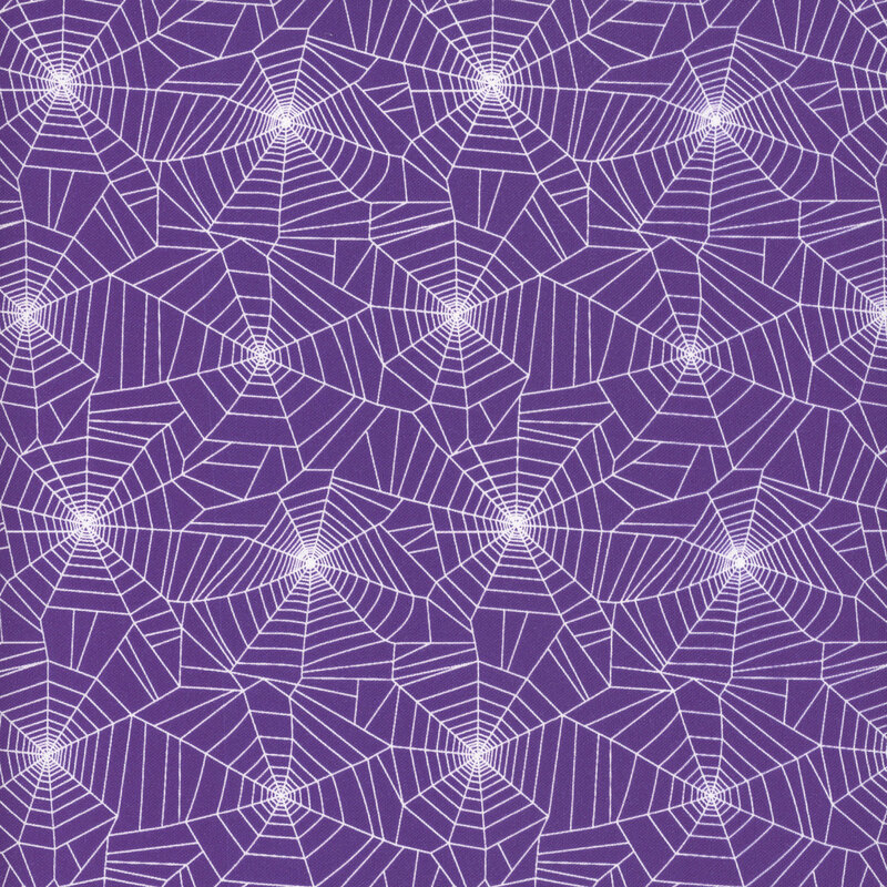 white spider webs on purple fabric