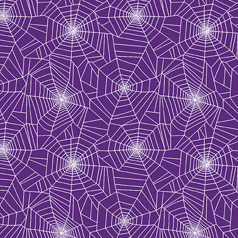 white spider webs on purple fabric