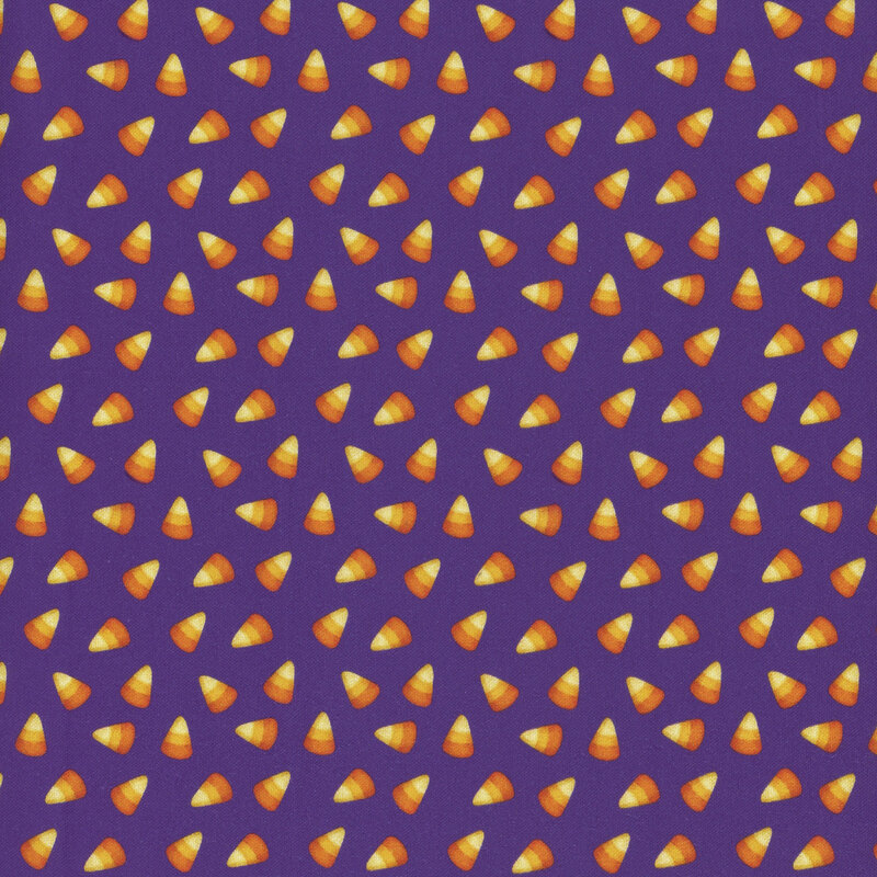 ditzy yellow, tangerine, and dark orange candy corn on a purple background.