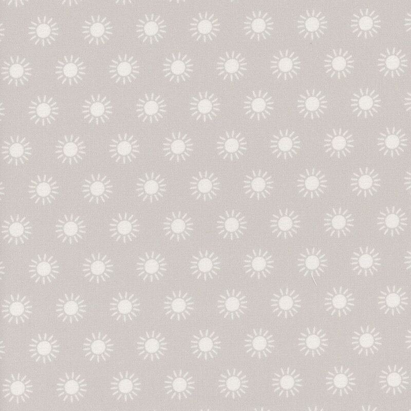 taupe fabric featuring rows of cream colored suns.