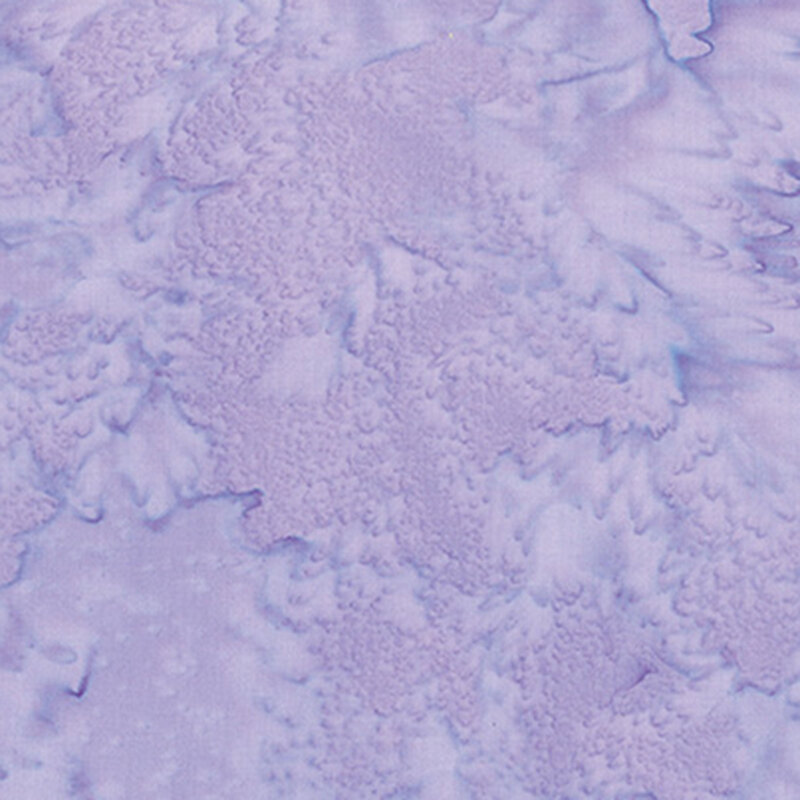 A tonal mottled light purple fabric. 