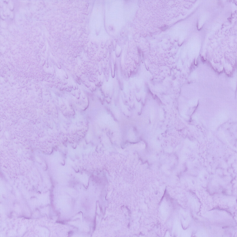A tonal mottled light purple fabric. 