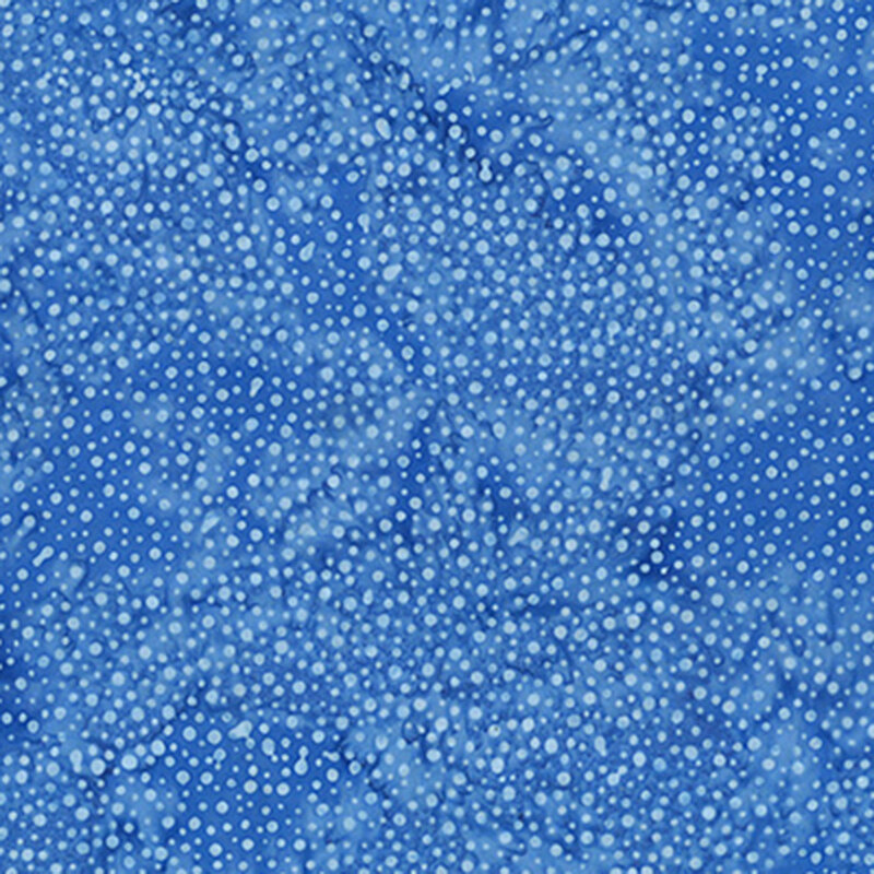 A tonal mottled blue fabric with lighter blue dots. 