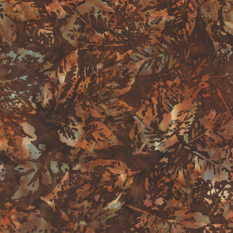 mottled dark brown batik fabric featuring orange and cream leaf imprints with a gray leaf shadows