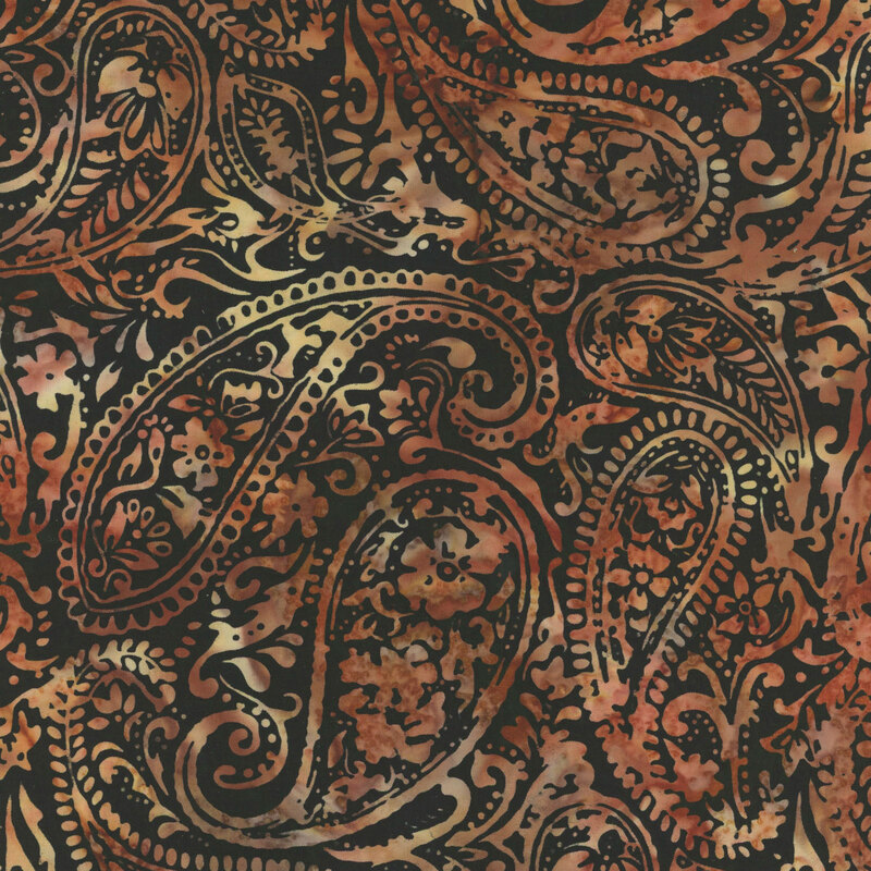 black batik fabric featuring mottled burnt sienna a floral paisley pattern