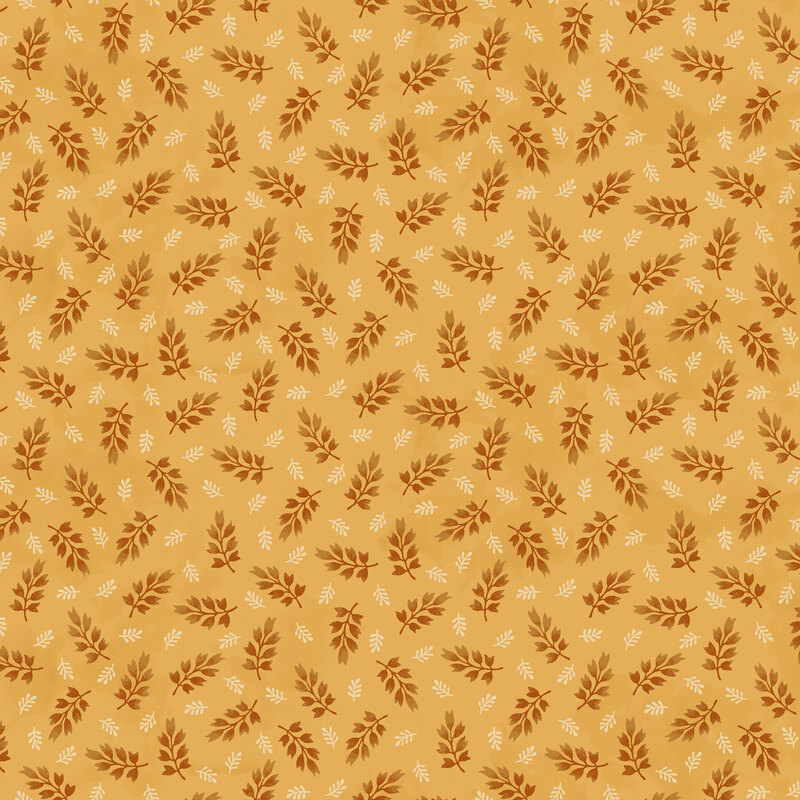 mottled ochre fabric featuring a ditsy print of dark orange and cream leaves