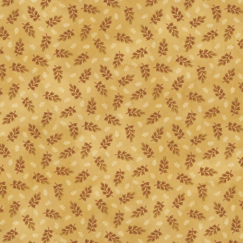 mottled ochre fabric featuring a ditsy print of dark orange and cream leaves