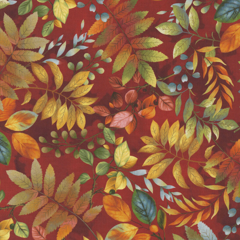 fall leaves beginning to turn from green to orange tossed on a mottled brick red background