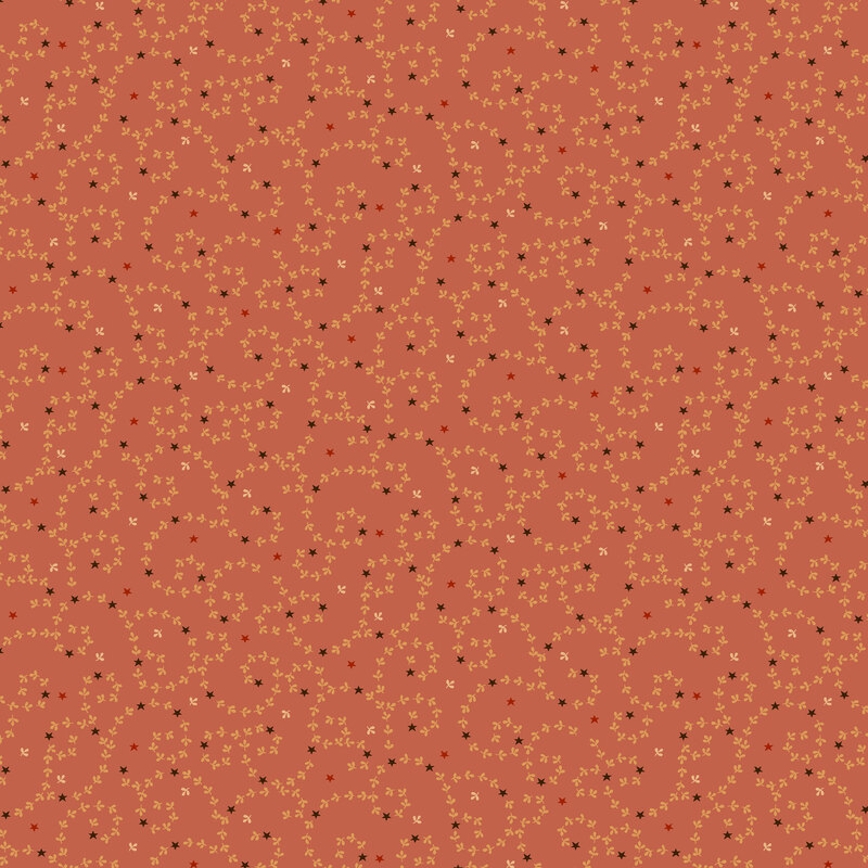 swirling tan flower buds tossed with black and orange stars salmon-orange fabric