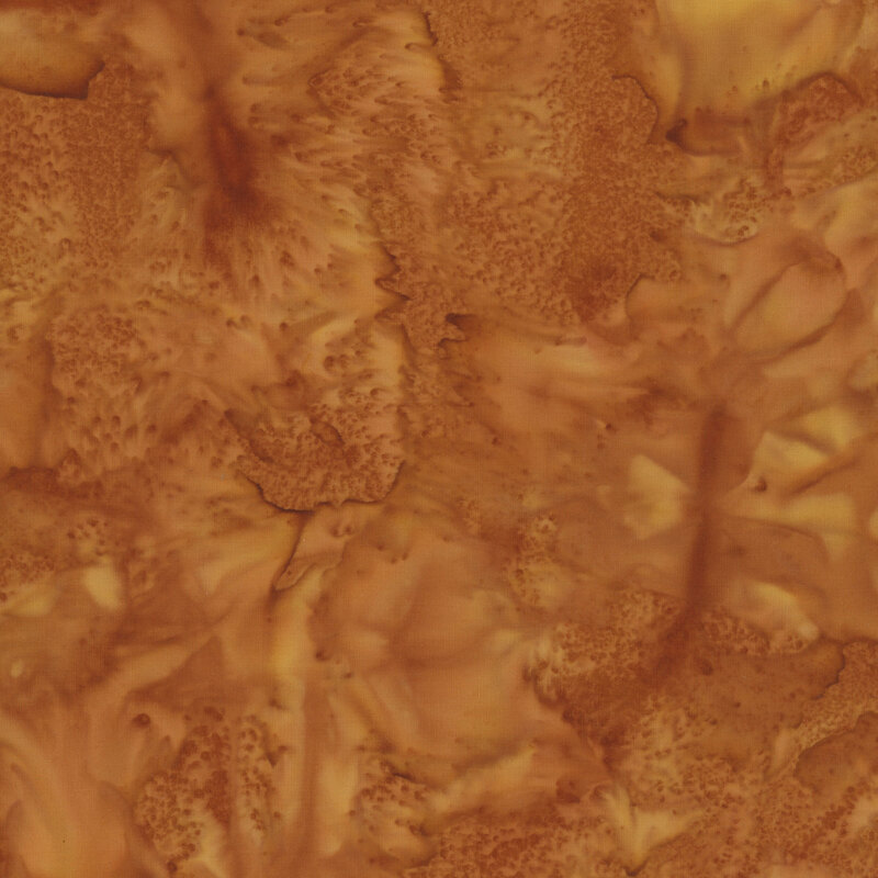 A mottled rust orange watercolor batik fabric.