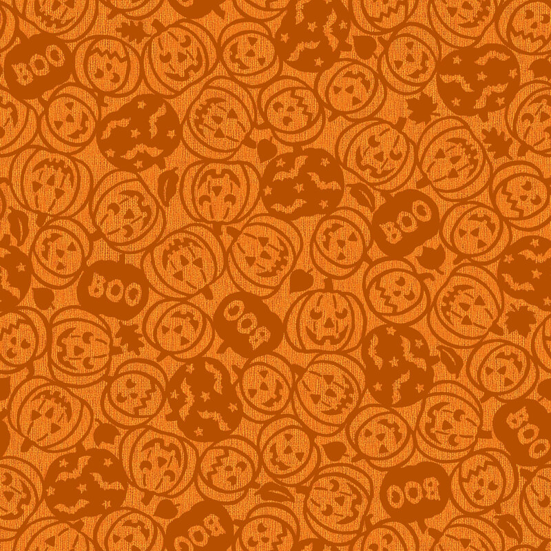 Pumpkin orange fabric tossed with carved pumpkins with spooky faces, boo, and bats in dark orange outlines.
