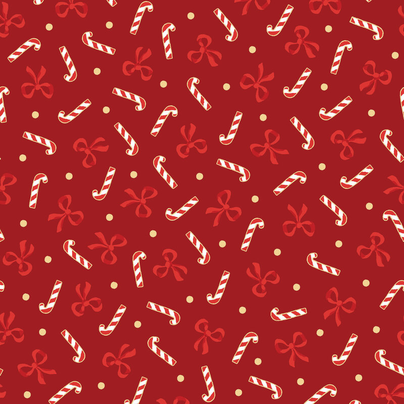 Crimson fabric with a tossed pattern of scarlet bows, candy canes, and gold dots