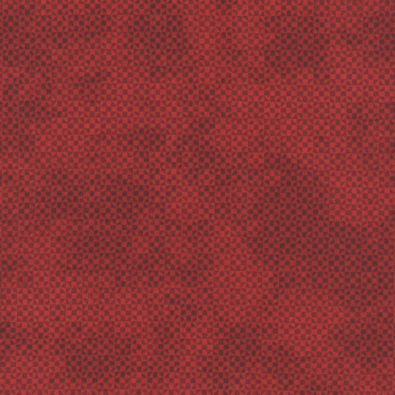 Mottled, tonal red fabric with a small geometric pattern