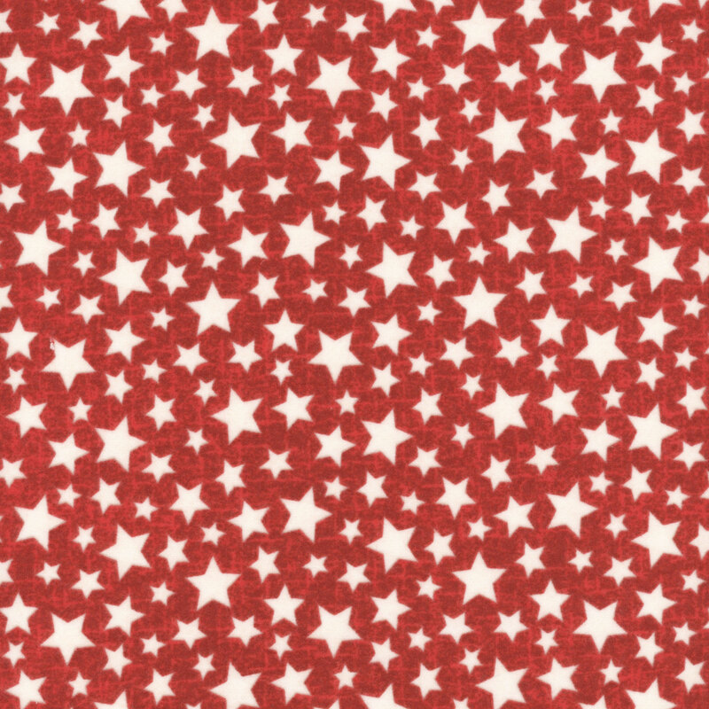White stars with brown outlines tossed on a textured red fabric