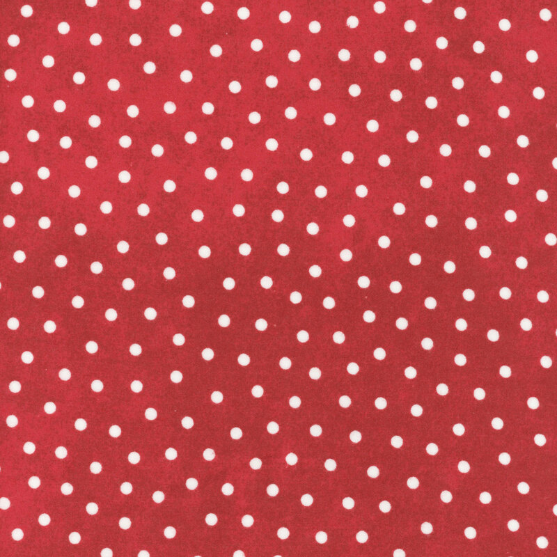 white polka dots scattered on a textured cranberry red background