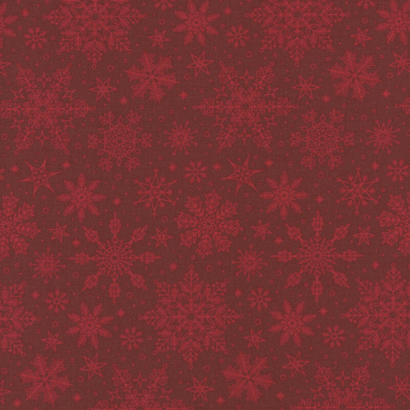 Ruby red fabric tossed with ornamental snowflakes.