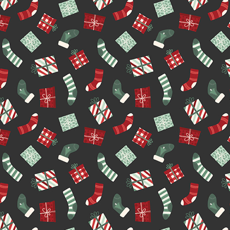 A black fabric with tossed stockings and christmas presents. 
