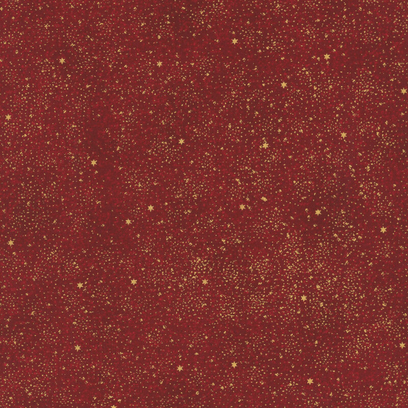 Mottled red fabric with tiny scattered stars and slight texturing with gold metallic accents.