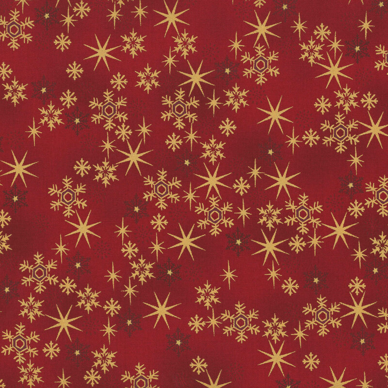Mottled red fabric with small, scattered stars and snowflakes with gold metallic accents.