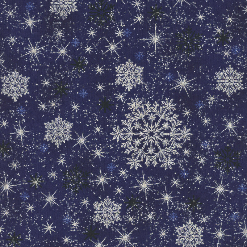 Mottled dark blue fabric with scattered snowflakes and stars with silver metallic accents.