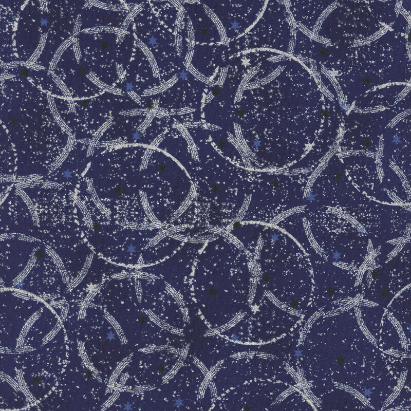 Mottled dark blue fabric with tiny scattered stars and overlapping, incomplete circles with silver metallic accents.