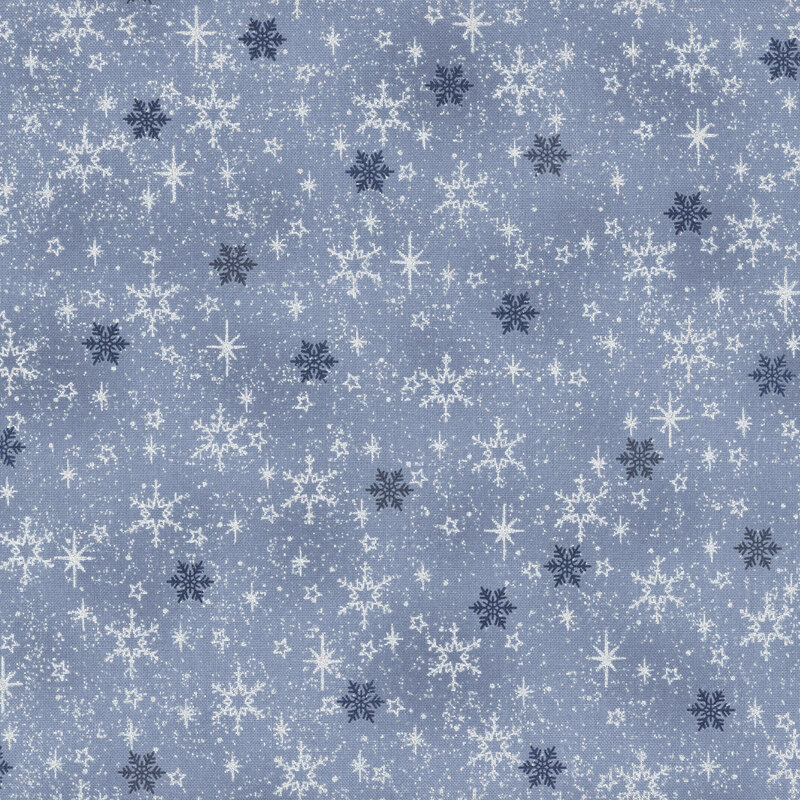 Mottled light blue fabric with small scattered snowflakes and stars with silver metallic accents.
