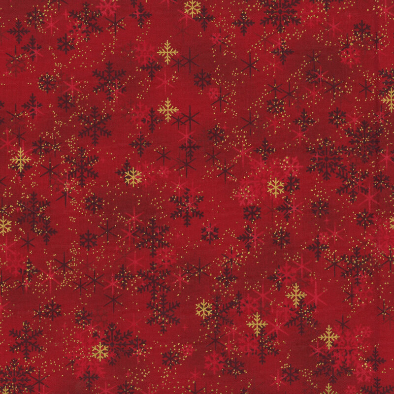 Mottled red fabric with scattered snowflakes, stars, and lightly flecked gold metallic.