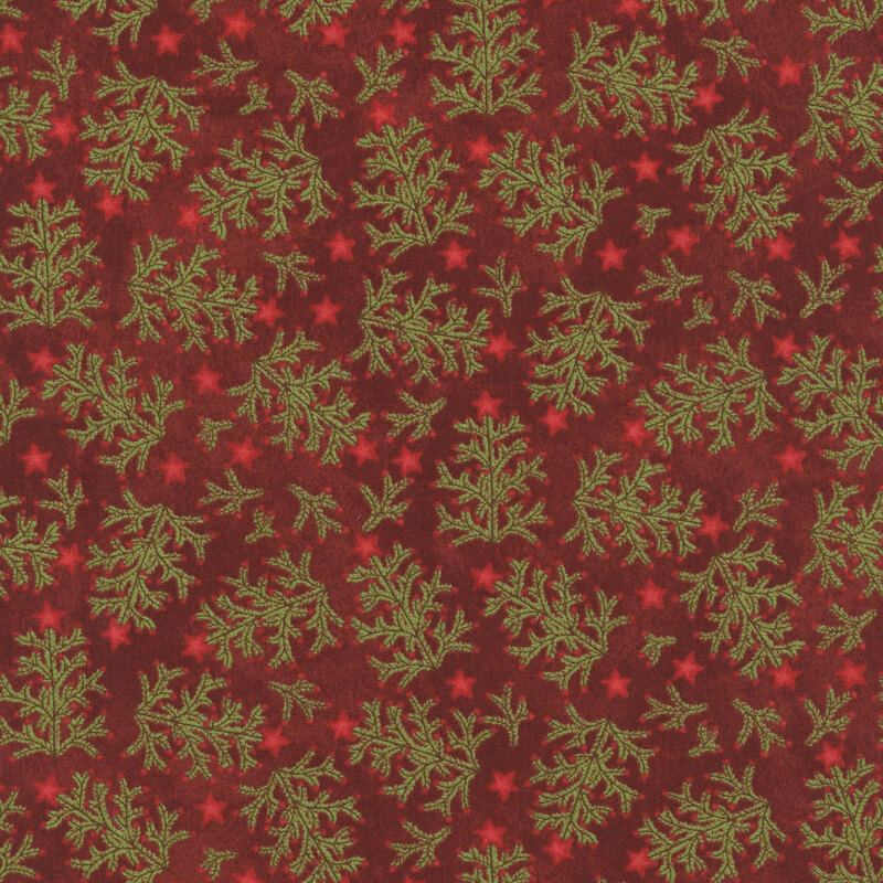 Crimson fabric with green fir tree branches topped with bright red stars