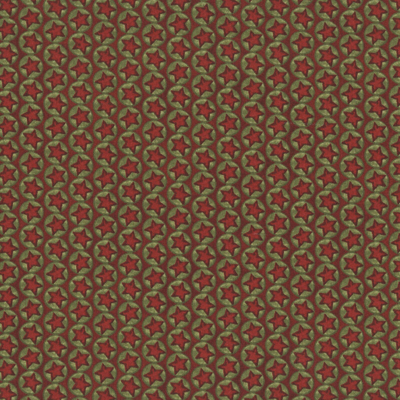 Cinnamon red fabric with lines of green circles with red stars in the center