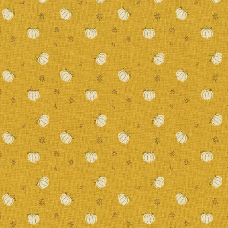 Gold fabric with a a ditsy pattern of white pumpkins and small brown twigs