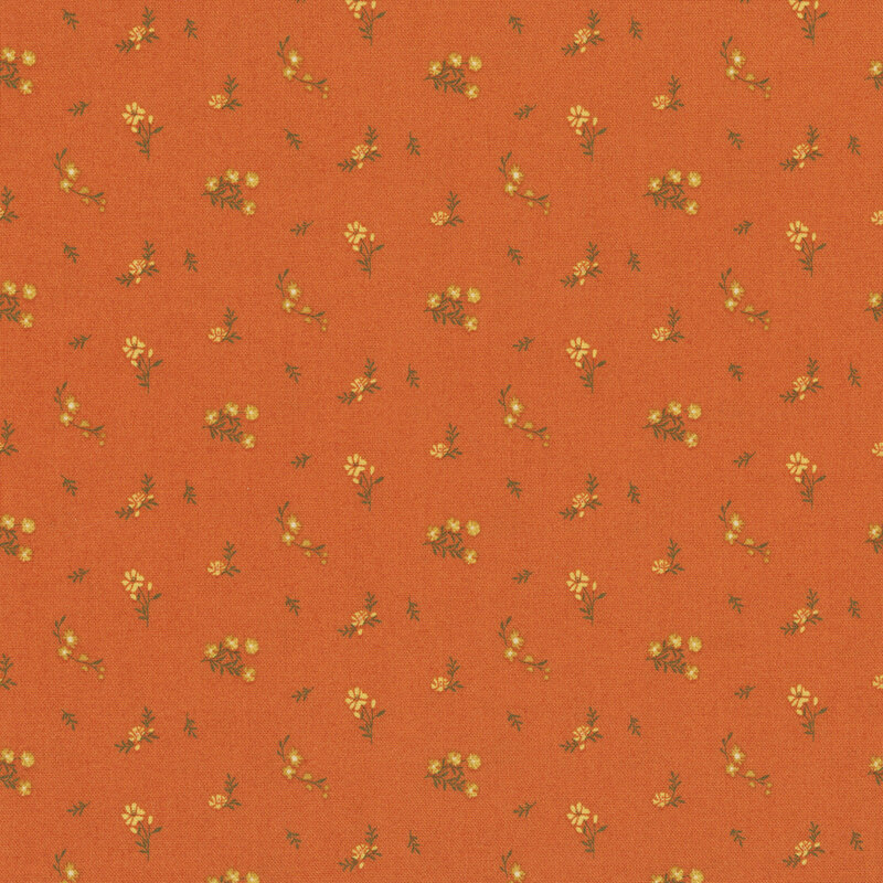 Pumpkin orange fabric with a ditsy print of yellow flowers and brown twigs