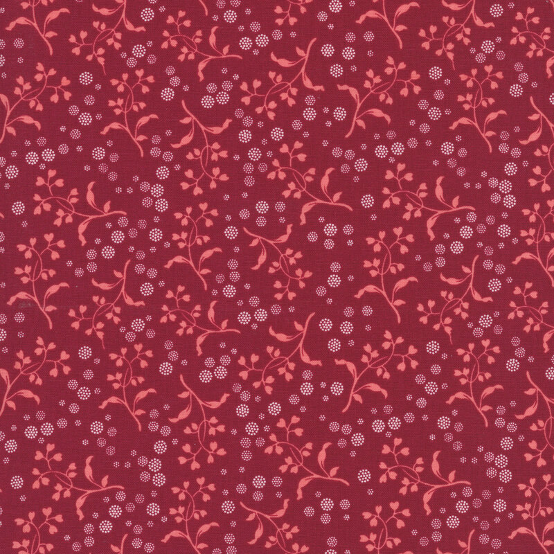 Cherry red fabric with a pattern of pink vines with heart-shaped leaves and white dotted circles