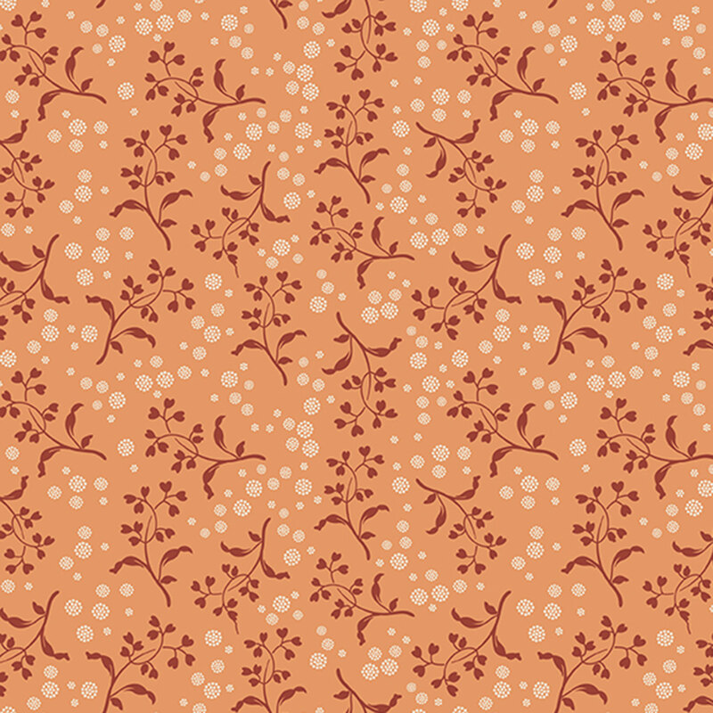 Peach background with a pattern of brick red vines with heart-shaped leaves and white dotted circles
