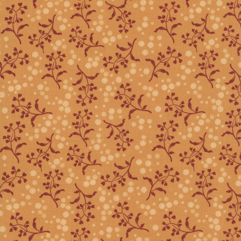 Peach fabric with a pattern of brick red vines with heart-shaped leaves and white dotted circles