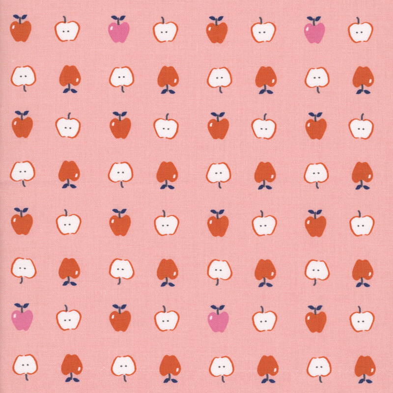 Light pink fabric with neat rows of red and pink apples both full and cut in half.