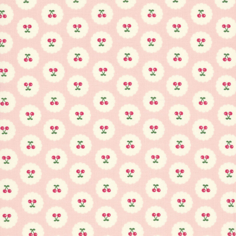 Pastel pink fabric with neat rows of upright and upside-down pairs of cherries on small white scalloped circles.