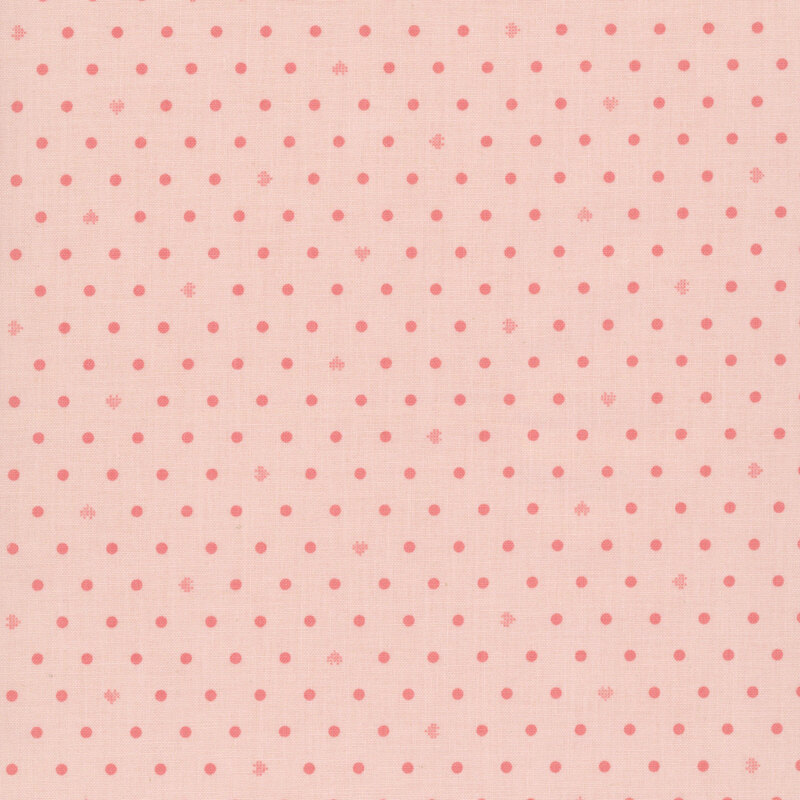 blush pink fabric with neat rows of polka dots and rotating pixellated hearts.