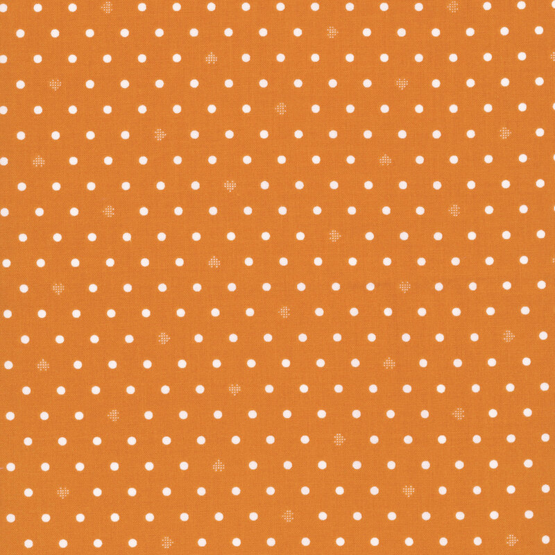 Bright orange fabric with neat rows of polka dots and rotating pixellated hearts.
