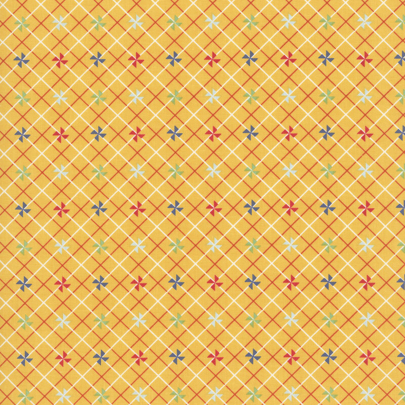 Golden yellow fabric with small colored pinwheels on a white and red lattice background.