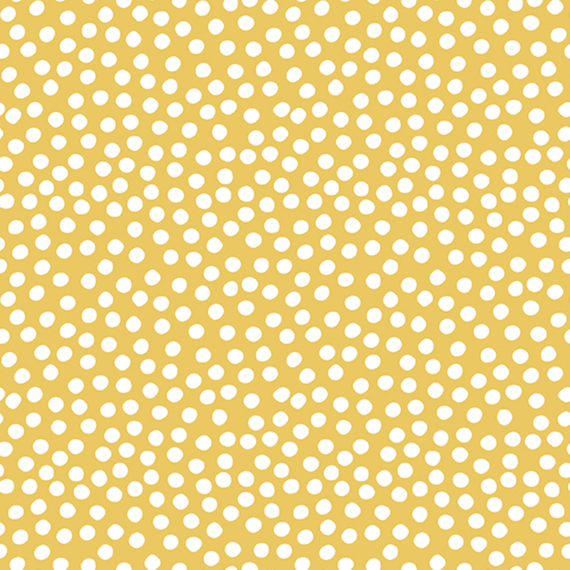 Yellow fabric with uneven white polka dots clustered together.
