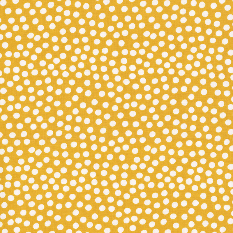 Yellow fabric with uneven white polka dots clustered together.