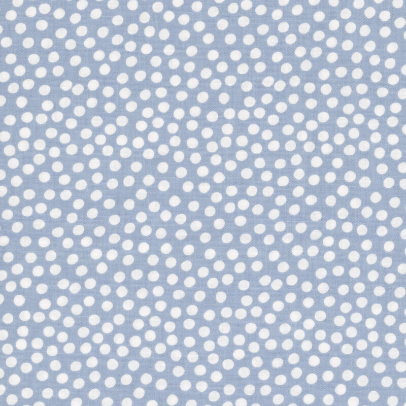 Dusty light blue fabric with uneven white polka dots clustered together.