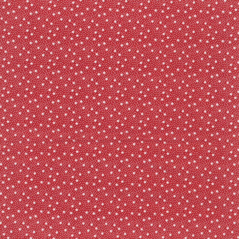 Red fabric with tiny white tossed stars and pinprick dots.