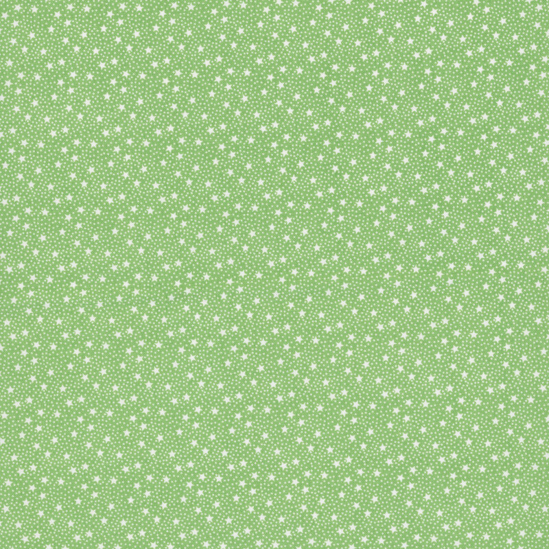 Grass green fabric with tiny white tossed stars and pinprick dots.