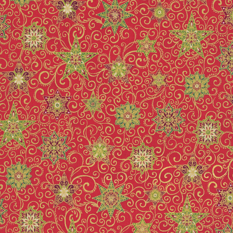 A red fabric with decorated stars, snowflakes, swirls, and gold metallic accents. 